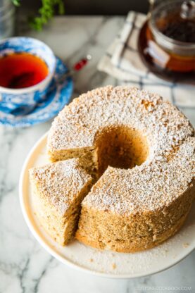 A plate containing Earl Grey Chiffon Cake dusted with powdered sugar on top.
