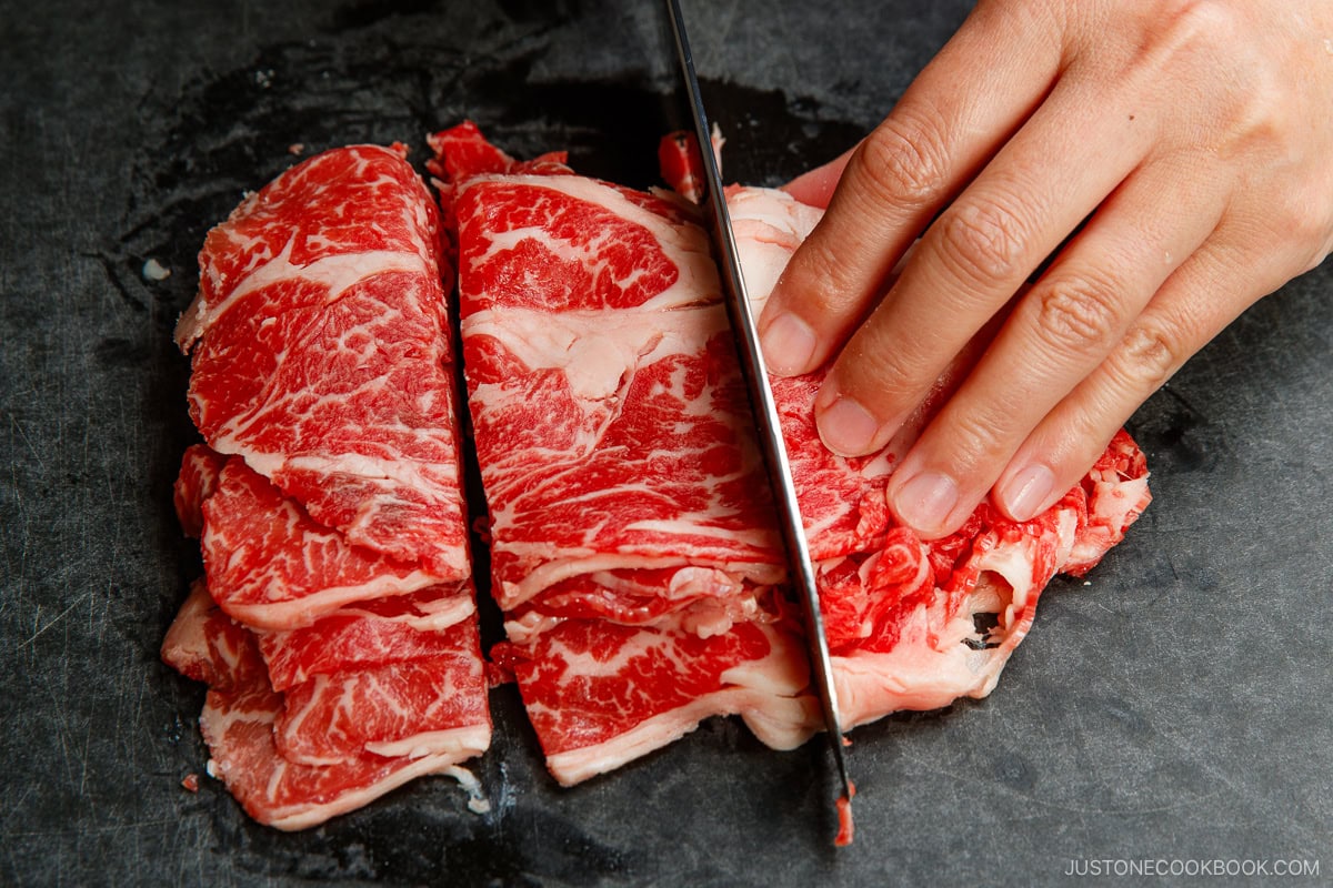 Cut thinly sliced meat into smaller pieces.