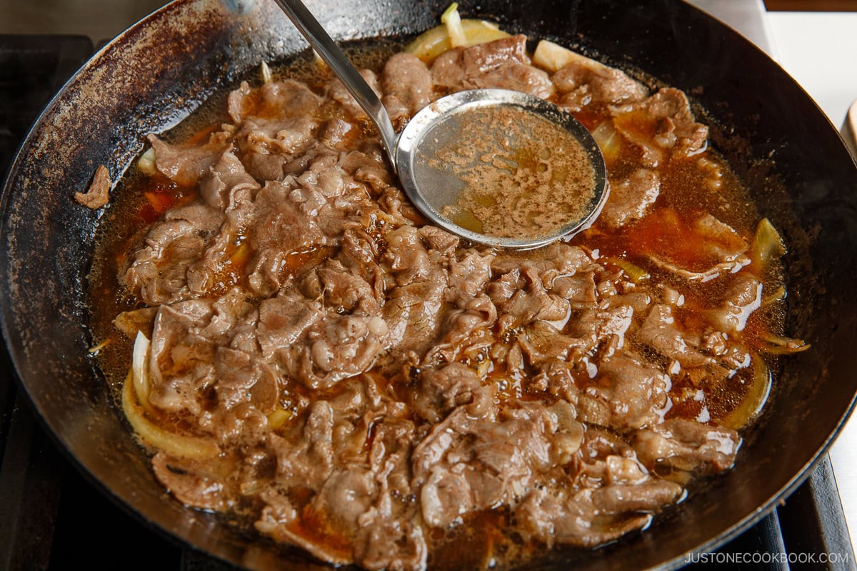 Skim the scum and fat over the simmering beef.