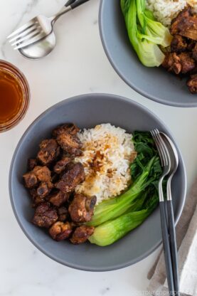 Instant pot honey spare ribs served with rice and steamed bok choy in a grey ceramic bowl.
