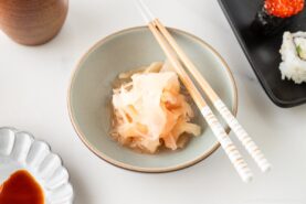Pickled Sushi Ginger is presented in a white ceramic bowl.