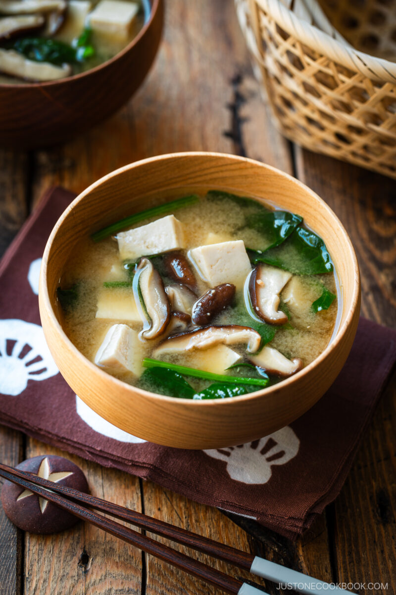 Wooden soup bowls containing Spinach and Mushroom Miso Soup.