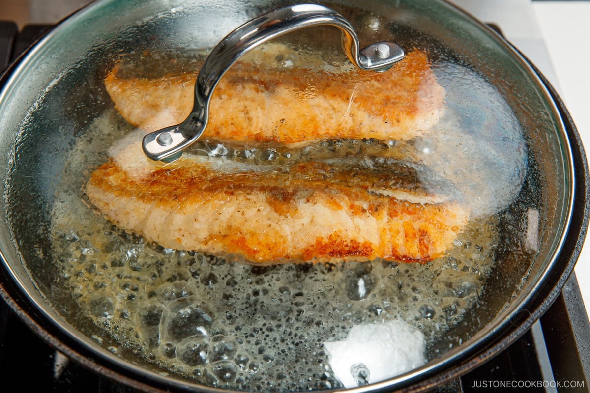 Steam the salmon fillets in the pan. 
