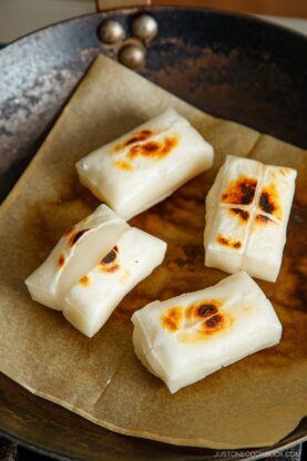 Toasting kiri mochi (Japanese rice cakes) in a frying pan.